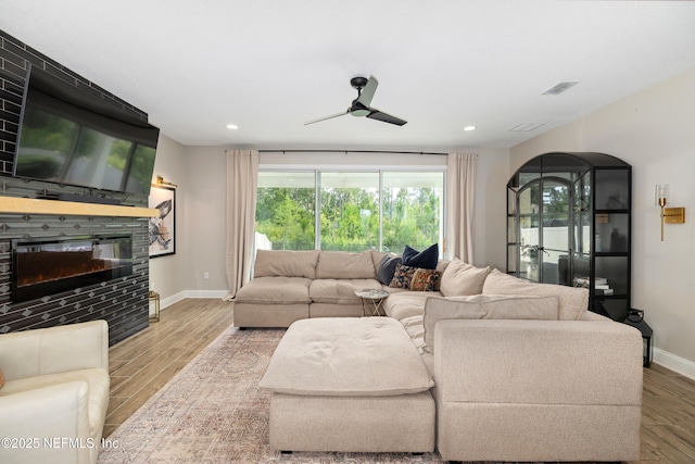 347 Ness Cir, Saint Augustine, FL 32095 - living room with a fireplace, a ceiling fan, wood finished floors, recessed lighting, and arched walkways