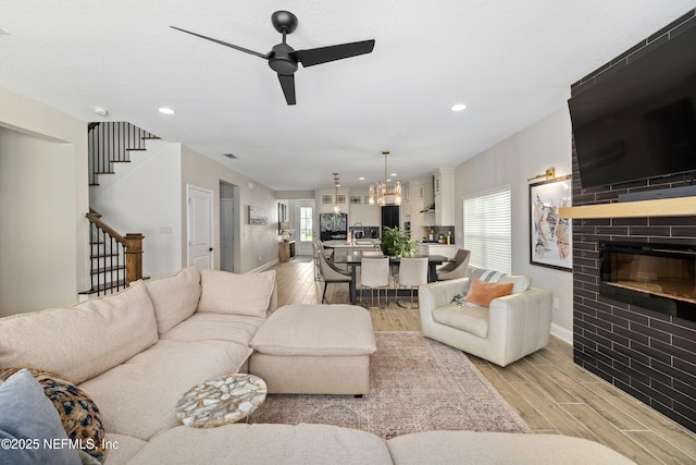 347 Ness Cir, Saint Augustine, FL 32095 - living room featuring light wood-style floors, stairway, ceiling fan, recessed lighting, and a fireplace