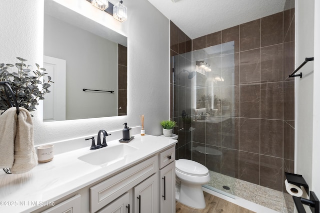 347 Ness Cir, Saint Augustine, FL 32095 - full bathroom featuring vanity, a shower stall, wood finished floors, and a textured wall