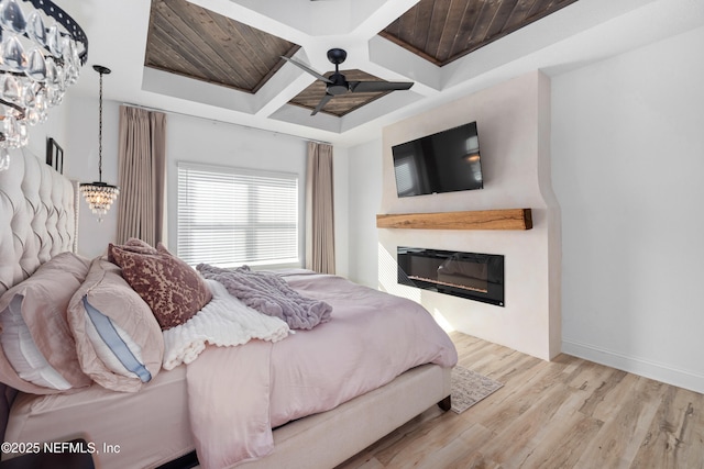 347 Ness Cir, Saint Augustine, FL 32095 - bedroom featuring coffered ceiling, a glass covered fireplace, wood finished floors, ceiling fan, and a chandelier