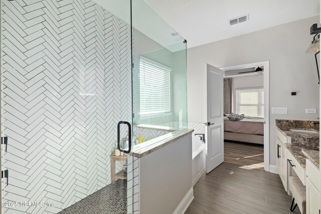 347 Ness Cir, Saint Augustine, FL 32095 - ensuite bathroom with a garden tub, a stall shower, vanity, and wood finished floors