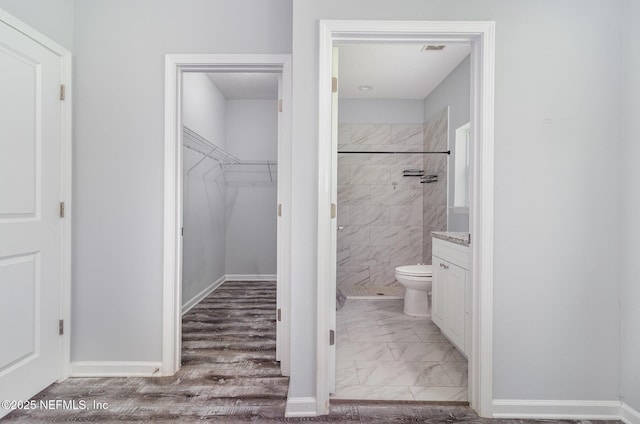 4725 Melanie St, Hastings, FL 32145 - full bathroom featuring a shower stall, vanity, marble look tile flooring, and a walk in closet