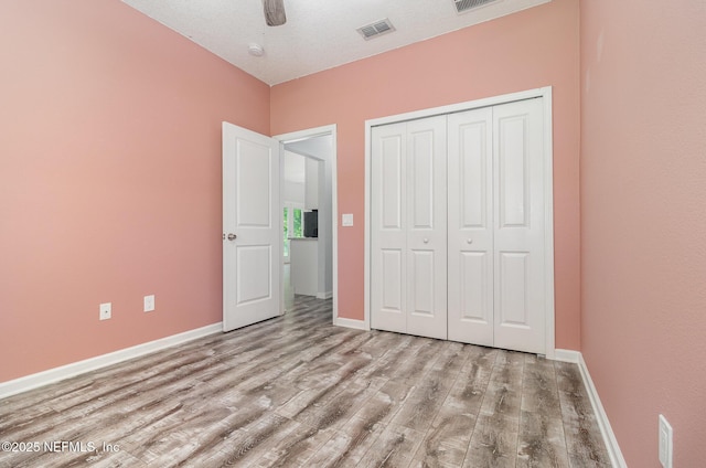 4725 Melanie St, Hastings, FL 32145 - unfurnished bedroom featuring wood finished floors, a closet, and a ceiling fan