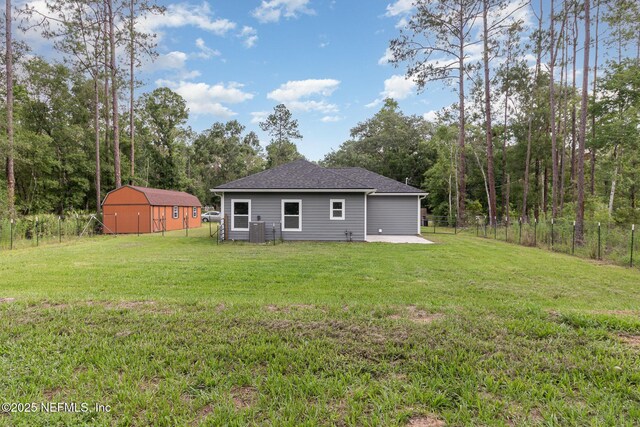 4725 Melanie St, Hastings, FL 32145 - rear view of house with a shed, a patio area, and roof with shingles