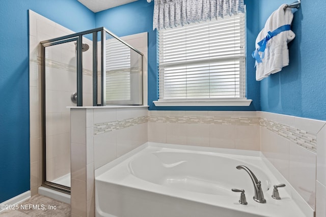 12206 Orange Grove Dr, Jacksonville, FL 32223 - full bath featuring a garden tub, a stall shower, plenty of natural light, and a textured wall