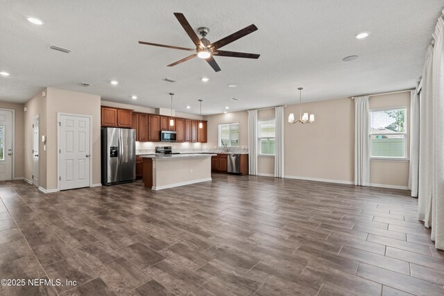 12206 Orange Grove Dr, Jacksonville, FL 32223 - kitchen featuring stainless steel appliances, a center island, light countertops, open floor plan, and a ceiling fan