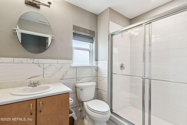 7250 Steventon Way, Jacksonville, FL 32244 - full bathroom with vanity, a stall shower, wainscoting, and tile walls