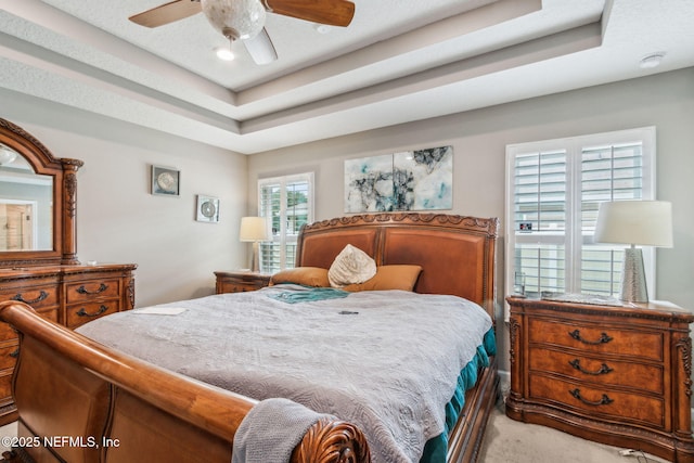 7250 Steventon Way, Jacksonville, FL 32244 - bedroom featuring a tray ceiling, carpet flooring, and a ceiling fan