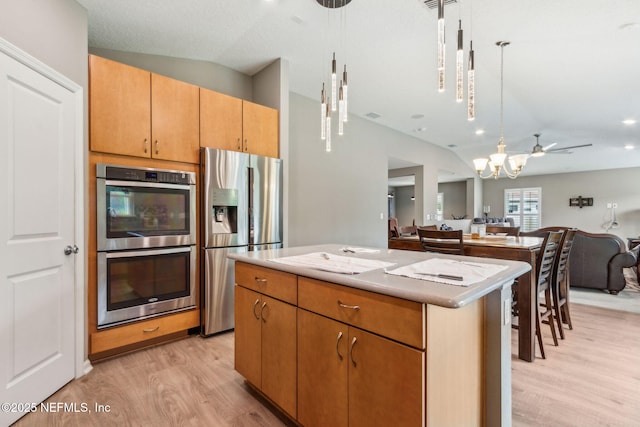 7250 Steventon Way, Jacksonville, FL 32244 - kitchen with appliances with stainless steel finishes, lofted ceiling, light wood-style floors, open floor plan, and a center island