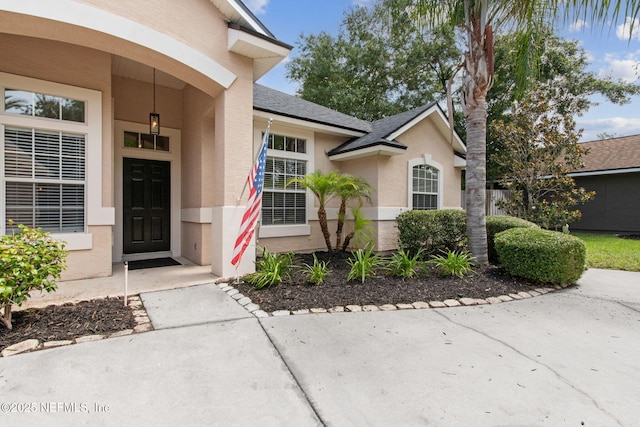 1912 Bluebonnet Way, Fleming Island, FL 32003 - property entrance featuring stucco siding and roof with shingles