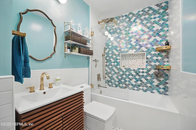 622 7th Ave N, Jacksonville Beach, FL 32250 - bathroom featuring tile walls, vanity, shower / bath combination, and a wainscoted wall