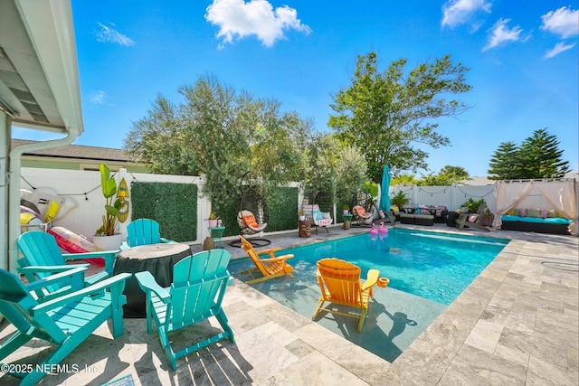 622 7th Ave N, Jacksonville Beach, FL 32250 - view of swimming pool featuring a patio area, a fenced backyard, and an outdoor living space with a fire pit