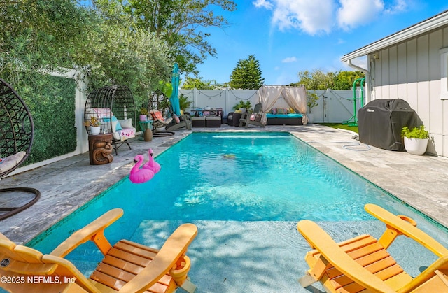 622 7th Ave N, Jacksonville Beach, FL 32250 - view of pool with a patio area, a fenced backyard, an outdoor living space, and area for grilling