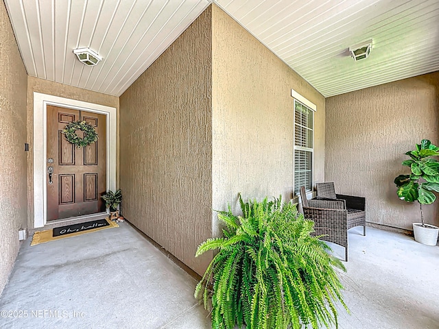 78151 Duckwood Trl, Yulee, FL 32097 - view of exterior entry featuring stucco siding and a porch