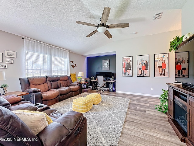78151 Duckwood Trl, Yulee, FL 32097 - living room featuring ceiling fan, lofted ceiling, a desk, light wood-type flooring, and a textured ceiling