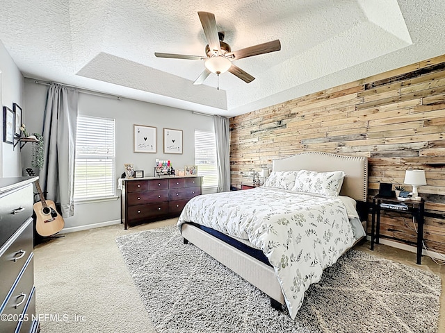 78151 Duckwood Trl, Yulee, FL 32097 - bedroom with a textured ceiling, wooden walls, light carpet, ceiling fan, and a raised ceiling