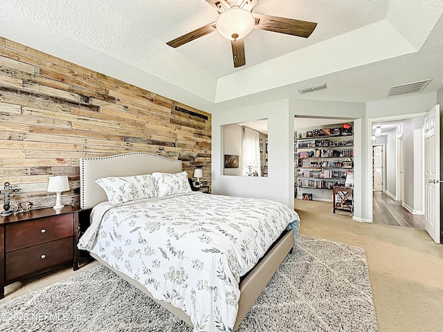 78151 Duckwood Trl, Yulee, FL 32097 - carpeted bedroom featuring wood walls, ceiling fan, and a textured ceiling