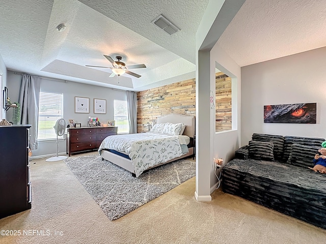 78151 Duckwood Trl, Yulee, FL 32097 - carpeted bedroom featuring a textured ceiling, multiple windows, a raised ceiling, and ceiling fan