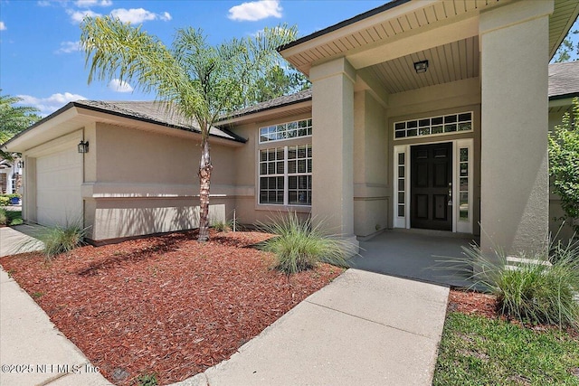 409 Spring Ridge Ct, Saint Augustine, FL 32092 - doorway to property featuring a garage and stucco siding