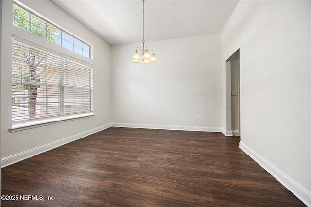 409 Spring Ridge Ct, Saint Augustine, FL 32092 - spare room featuring a chandelier, dark wood-style floors, and a textured ceiling