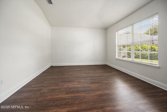 409 Spring Ridge Ct, Saint Augustine, FL 32092 - spare room featuring dark wood-style flooring and a textured ceiling