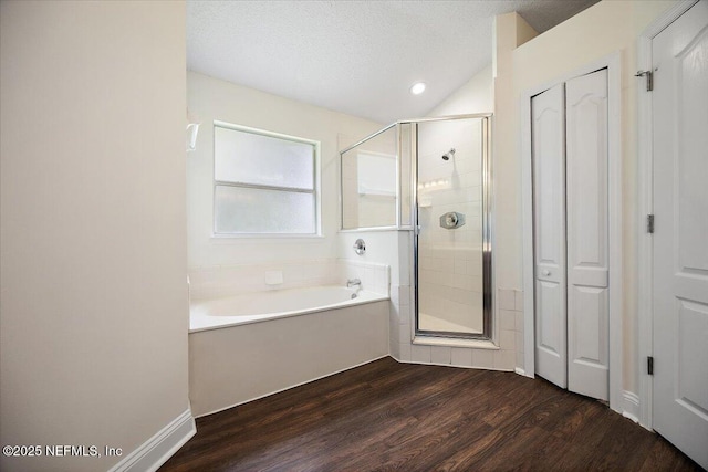 409 Spring Ridge Ct, Saint Augustine, FL 32092 - full bathroom with a closet, a garden tub, a stall shower, wood finished floors, and a textured ceiling