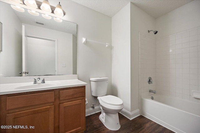 409 Spring Ridge Ct, Saint Augustine, FL 32092 - full bathroom featuring wood finished floors, vanity,  shower combination, and a textured ceiling