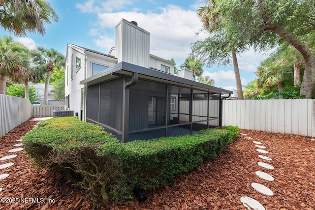 511 Selva Lakes Cir, Atlantic Beach, FL 32233 - rear view of house with a chimney, a sunroom, and a fenced backyard