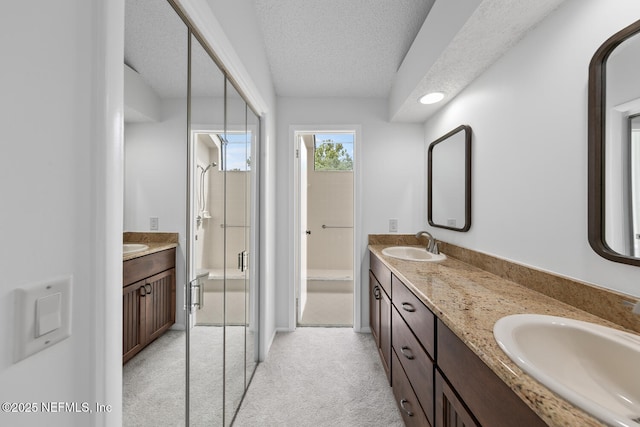 511 Selva Lakes Cir, Atlantic Beach, FL 32233 - bathroom featuring double vanity, a stall shower, and a textured ceiling