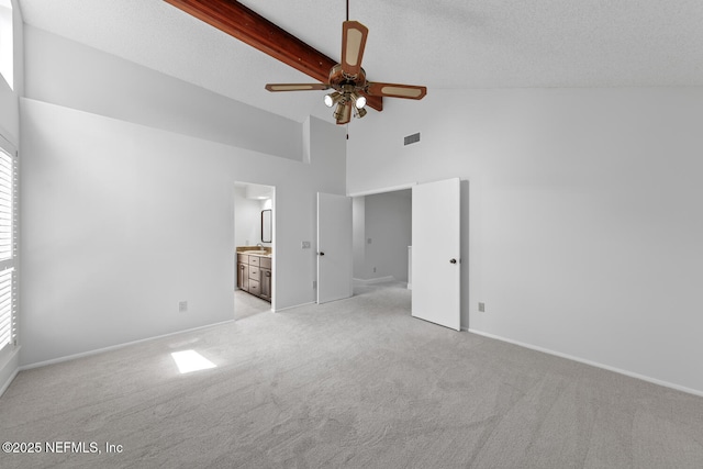 511 Selva Lakes Cir, Atlantic Beach, FL 32233 - unfurnished bedroom featuring light colored carpet, high vaulted ceiling, ensuite bath, and beamed ceiling