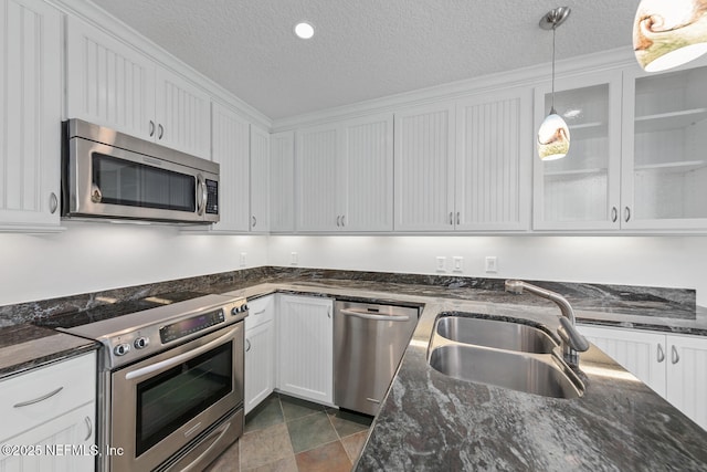 511 Selva Lakes Cir, Atlantic Beach, FL 32233 - kitchen with appliances with stainless steel finishes, a textured ceiling, white cabinets, pendant lighting, and dark stone counters
