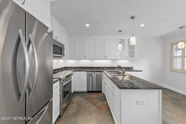 511 Selva Lakes Cir, Atlantic Beach, FL 32233 - kitchen featuring stainless steel appliances, a textured ceiling, white cabinetry, dark stone counters, and recessed lighting