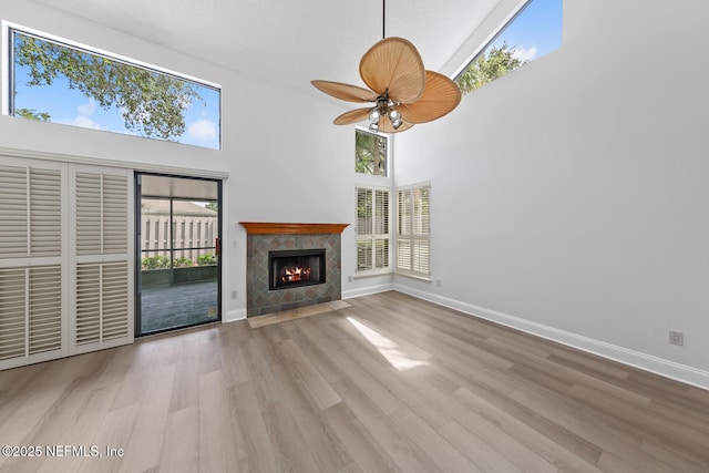 511 Selva Lakes Cir, Atlantic Beach, FL 32233 - unfurnished living room with high vaulted ceiling, ceiling fan, healthy amount of natural light, and wood finished floors