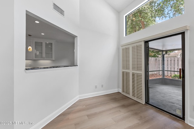 511 Selva Lakes Cir, Atlantic Beach, FL 32233 - doorway with wood finished floors, healthy amount of natural light, a high ceiling, and recessed lighting