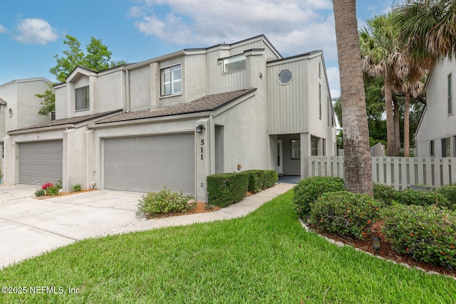 511 Selva Lakes Cir, Atlantic Beach, FL 32233 - townhome / multi-family property with stucco siding, concrete driveway, a garage, and roof with shingles