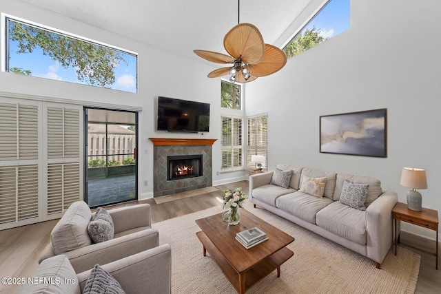 511 Selva Lakes Cir, Atlantic Beach, FL 32233 - living area with high vaulted ceiling, healthy amount of natural light, wood finished floors, and a tiled fireplace
