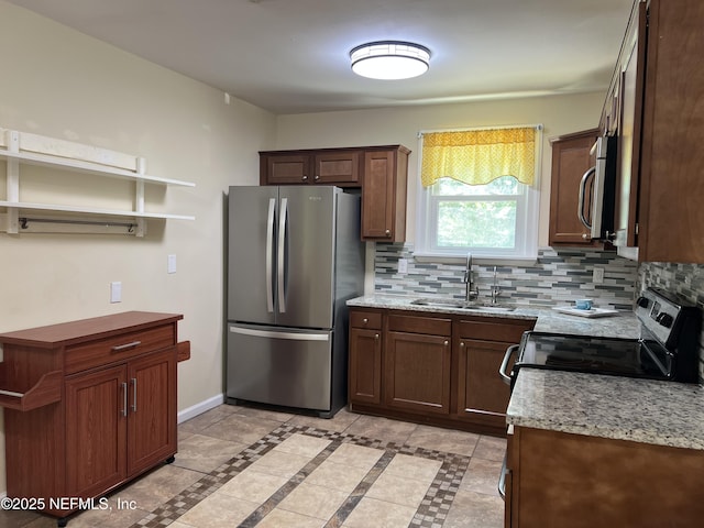 1612 Greenridge Rd, Jacksonville, FL 32207 - kitchen featuring stainless steel appliances, open shelves, backsplash, and light stone counters