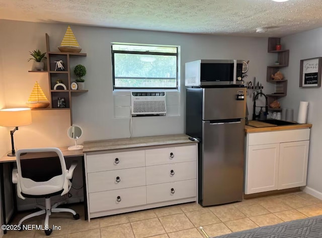 1612 Greenridge Rd, Jacksonville, FL 32207 - kitchen featuring stainless steel appliances, a textured ceiling, white cabinets, light countertops, and light tile patterned flooring