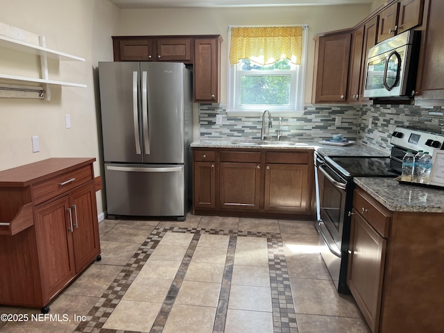 1612 Greenridge Rd, Jacksonville, FL 32207 - kitchen featuring stainless steel appliances, decorative backsplash, and stone counters