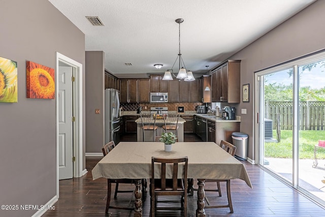 1341 River City St, Saint Augustine, FL 32092 - dining area featuring dark wood finished floors and a chandelier