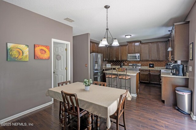 1341 River City St, Saint Augustine, FL 32092 - dining space featuring dark wood-style flooring and baseboards