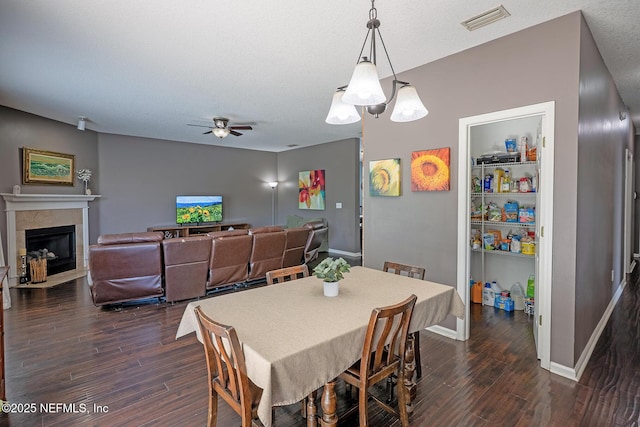 1341 River City St, Saint Augustine, FL 32092 - dining space with dark wood-type flooring, a ceiling fan, and a fireplace with flush hearth