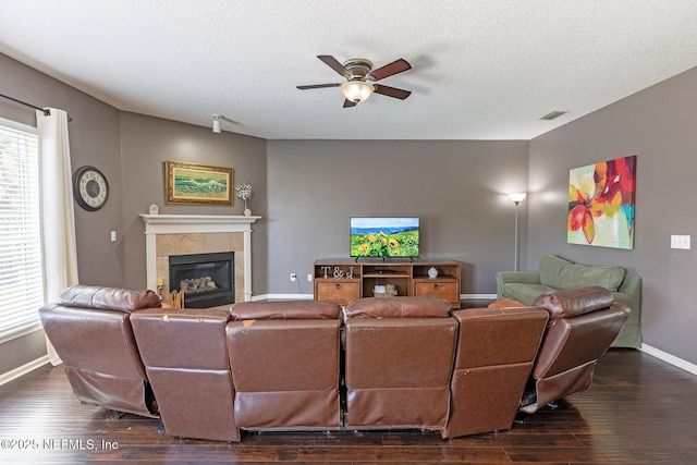 1341 River City St, Saint Augustine, FL 32092 - living room featuring ceiling fan, a fireplace, dark wood-style floors, and a textured ceiling