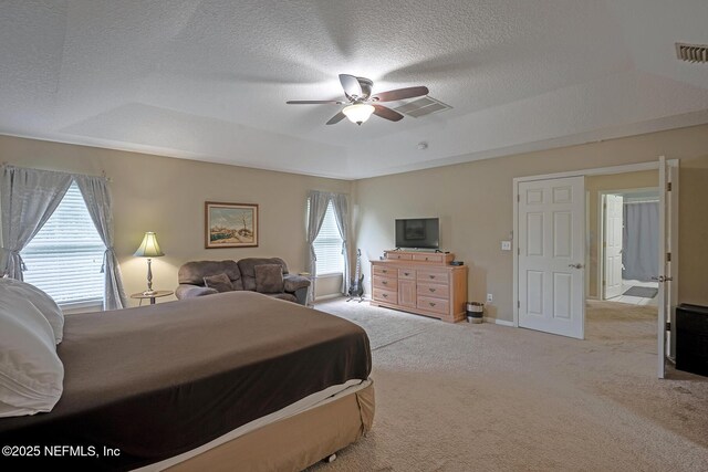 1341 River City St, Saint Augustine, FL 32092 - bedroom with a tray ceiling, light carpet, a textured ceiling, and a ceiling fan