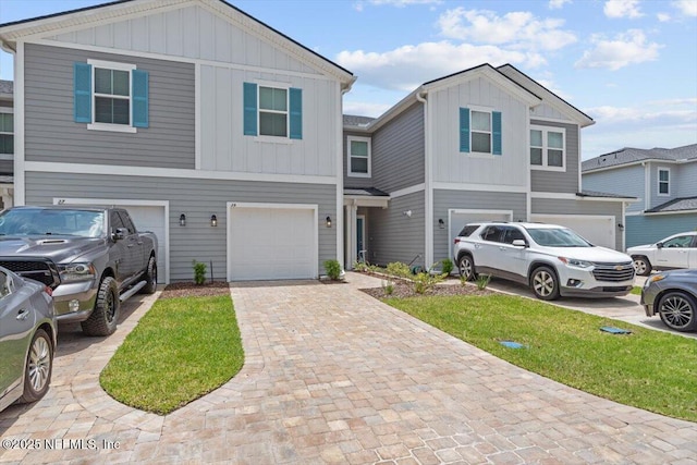 39 Thurnham Ln, Saint Augustine, FL 32092 - townhome / multi-family property with an attached garage, board and batten siding, decorative driveway, and a front lawn