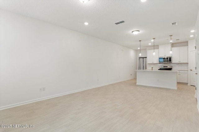 39 Thurnham Ln, Saint Augustine, FL 32092 - unfurnished living room with recessed lighting and light wood-type flooring