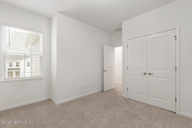 39 Thurnham Ln, Saint Augustine, FL 32092 - unfurnished bedroom featuring carpet floors, a closet, and a textured ceiling