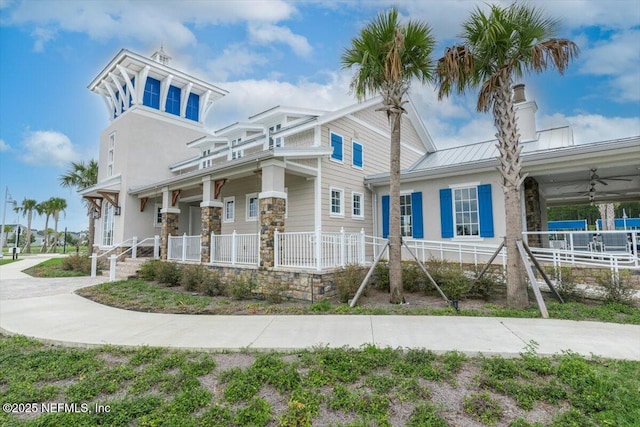 39 Thurnham Ln, Saint Augustine, FL 32092 - view of front of house with a porch, a standing seam roof, stone siding, and a ceiling fan