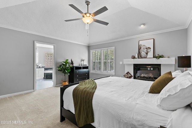 433 Big Tree Rd, Ponte Vedra Beach, FL 32082 - carpeted bedroom featuring a glass covered fireplace, crown molding, lofted ceiling, connected bathroom, and ceiling fan