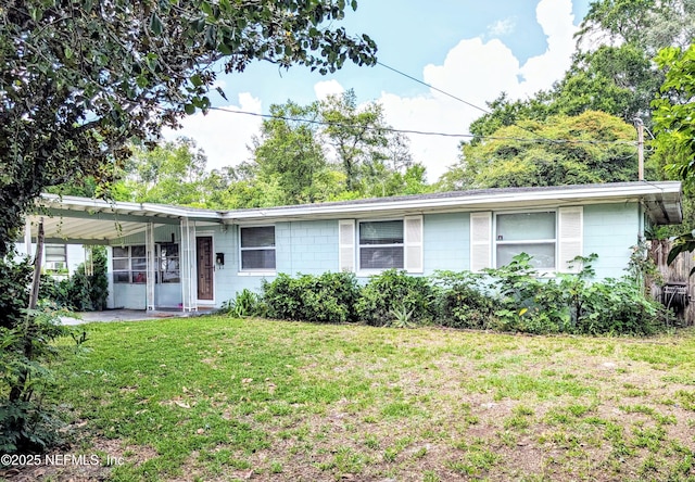 7505 Mayapple Rd, Jacksonville, FL 32211 - ranch-style house with a front lawn and concrete block siding